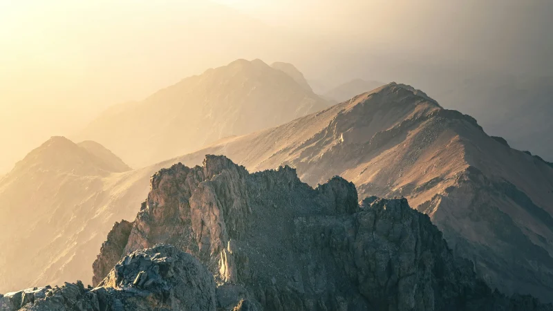 Snow-capped Mount Toubkal and surrounding Atlas Mountains with traditional Berber villages nestled below.